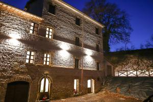 een groot bakstenen gebouw met lichten aan de zijkant bij IL MOLINO del SIGNORE in Pergola