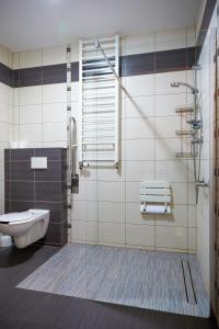 a bathroom with a shower and a toilet and a sink at PLATINIUM House ex Royal House in Białogard +8 photos