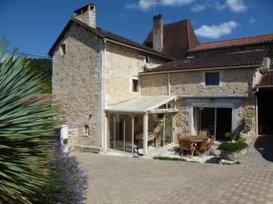 a house with an awning on the side of it at La Colline Truffière in Sourzac