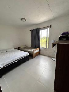 ein Schlafzimmer mit einem Bett und einem Fenster in der Unterkunft Casa, Punta del Este in Punta del Este + 14 Fotos