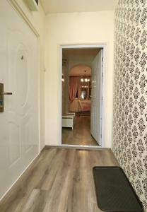 an empty hallway with a door and a rug on the floor at DARA Apatman in Šabac