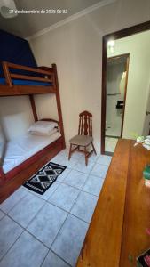 una camera da letto con un letto a castello e una sedia di Apartamento à 5min à pé da Praia a Ubatuba Altre 27 foto