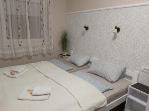 a bedroom with a bed with two pillows on it at Filigran in Palić +70 photos