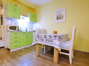 a kitchen with a table with a sign on it at DARA Apatman in Šabac +5 photos