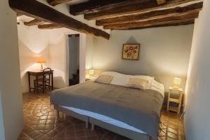 a bedroom with a bed and a table in a room at Domaine Les Pigées in Saint-Privé +24 photos