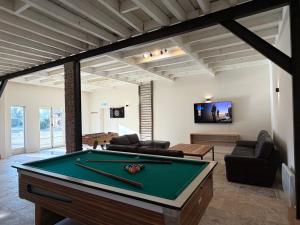 a living room with a pool table in it at Domaine Les Pigées in Saint-Privé