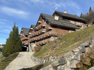 a large building on top of a hill at Appartement 3 pièces, 6 pers, proche pistes, parking - FR-1-180-365 in Les Allues