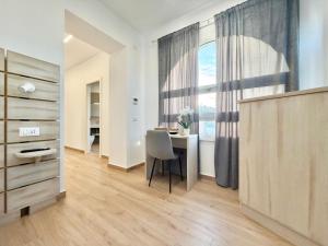 a room with a table and a chair and a window at Maison Plancina in Rome