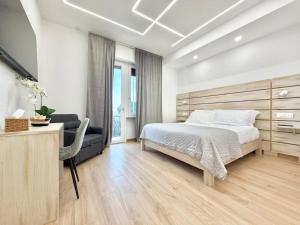 a bedroom with a bed and a desk and a television at Maison Plancina in Rome +15 photos