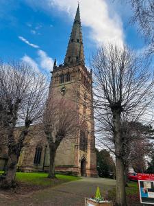 een kerk met een hoge toren met bomen voor de deur bij Churchill Apartment- 4 Beds- Free Parking- Near NEC BHX & HS2 in Coleshill