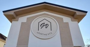 a building with a sign on the top of it at GV Apartments in Caserta
