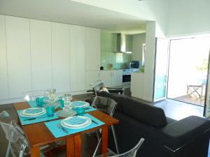 a living room with a table and a couch at Odeceixe Vila in Odeceixe