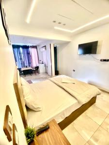 a room with a bed and a tv on a wall at Pyramids fort & Free Pick-up in Cairo