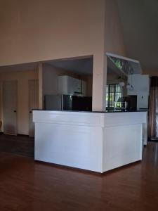a white counter in a room with a kitchen at A few steps from the beach in Pereybere