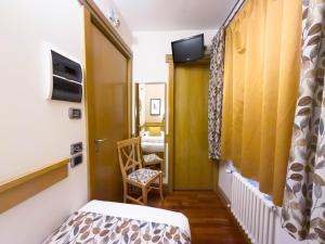 a small room with a bed and a chair at IL Postale in Castel di Sangro