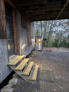 a wooden bench sitting outside of a building at Villa Mammouth in Saint Alban Auriolles