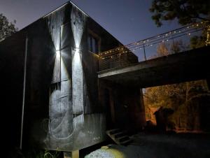 a building with a bridge with graffiti on it at Villa Mammouth in Saint Alban Auriolles