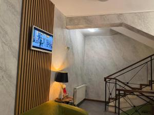 a living room with a staircase and a green couch at Family Hotel Lazur in Bansko