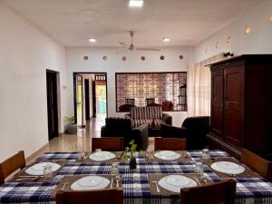 a dining room with a table and a living room at Villa 277 - Mirissa in Bandaramulla