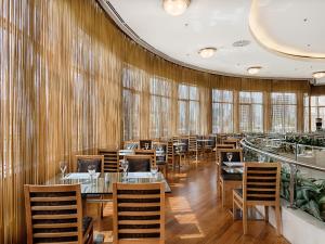 a restaurant with tables and chairs and windows at WOW Istanbul Hotel in Istanbul