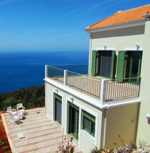 een huis met een balkon met uitzicht op de oceaan bij Porto Katsiki Blu in Athanion