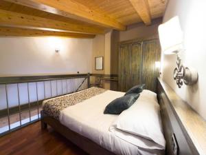 a bedroom with a bed in a room with wooden ceilings at IL Postale in Castel di Sangro