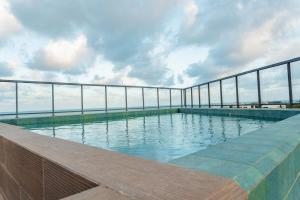 a swimming pool on the top of a building at Beira Mar - Melhor Localização Bessa Five in João Pessoa