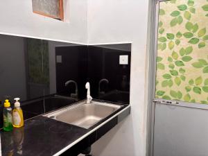 a kitchen counter with a sink and a mirror at Villa 277 - Mirissa in Bandaramulla +12 photos