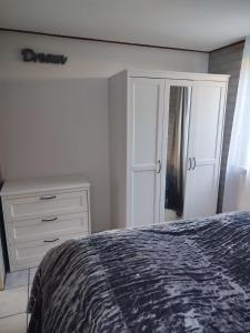una camera da letto con un letto, un comò e uno specchio di Gemütliches, komfortables Ferienhaus a Schoorl