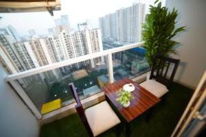 a balcony with a table and chairs and a view of a city at Lux 1bhk with balcony in Noida +7 photos