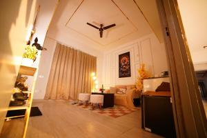 a living room with a couch and a table at Lux 1bhk with balcony in Noida