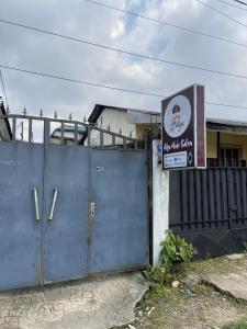 a building with a blue gate and a sign on it at One-bedroom self-contained accommodation in a private villa in Douala