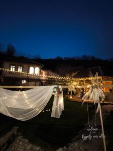 a white tent with lights in a yard at night at Vila Kruna in Pirot