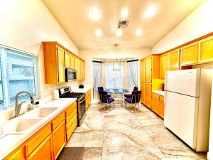 a kitchen with a table and a white refrigerator at Sweet Holiday in Antelope