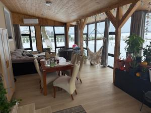 a dining room and living room with a table and chairs at Apartament Willa Dom wakacyjny Agroturystyka Zacisze11 Idealny dla rodzin z dziećmi Holiday Home Vacation House",Cały dom na wyłączność in Węgorzyn