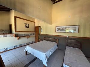 En eller flere senge i et værelse på FLATS e SUÍTES NATIVA