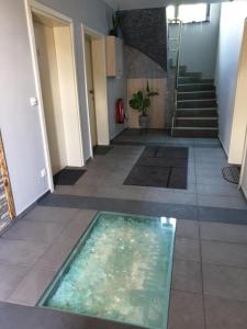 a hallway with a pool of water on the floor at Andromachi Apartments in Jembke