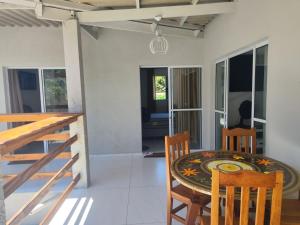 a dining room with a table and chairs at Casa Aconchegante in Bertioga