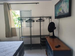 a bedroom with a bed and a desk with four lights at Casa Aconchegante in Bertioga