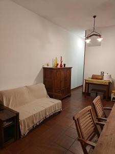 a living room with a couch and a table at Appartamento Rialto Terminillo in Terminillo
