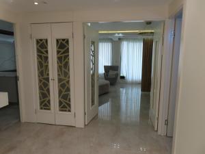 a living room with white cabinets and a couch at Gedera Rental in Gedera