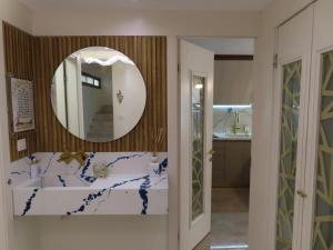 a bathroom with a sink and a mirror at Gedera Rental in Gedera +21 photos