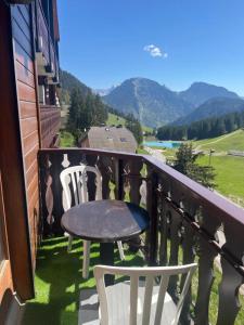een tafel en stoelen op een balkon met uitzicht bij Evasion Alpine in Le Biot