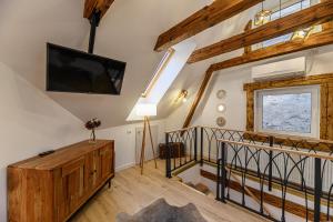 a living room with a flat screen tv on the wall at Republicii Residence in Braşov