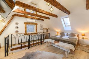 a bedroom with a bed in a room with wooden ceilings at Republicii Residence in Braşov