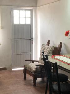 a room with a door and a chair and a bed at Iberá in Mercedes