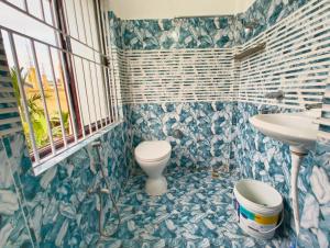 a bathroom with a toilet and a sink at Premium AC Rooms at Taj Heritage Hotel and Restatrant in Jorhat