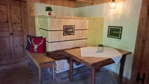 a room with a wooden table and bench in a room at Ferienhütte See 4 in Seeberg +17 photos