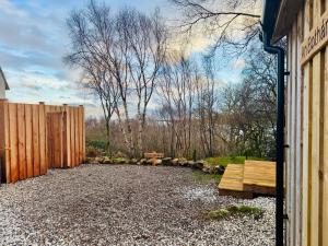a backyard with a bench and a fence at An Bothan in Isleornsay