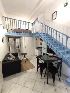 een woonkamer met een blauwe trap en een tafel bij Miniloft scala blu in Milaan